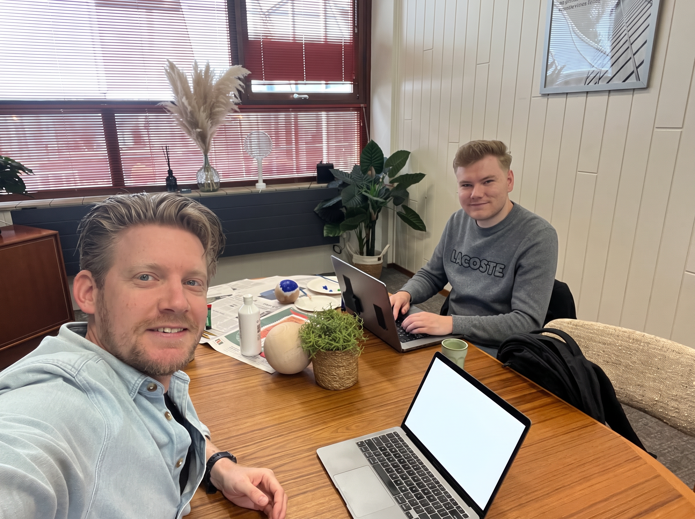 Sander en Jorn, oprichters van Paintabol, achter een tafel met een houten bol en verf